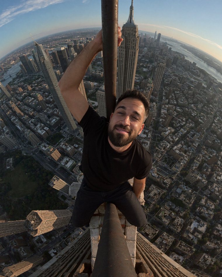 Michele De Vivo, MichyDev, hanging off a skyscraper spire in New York